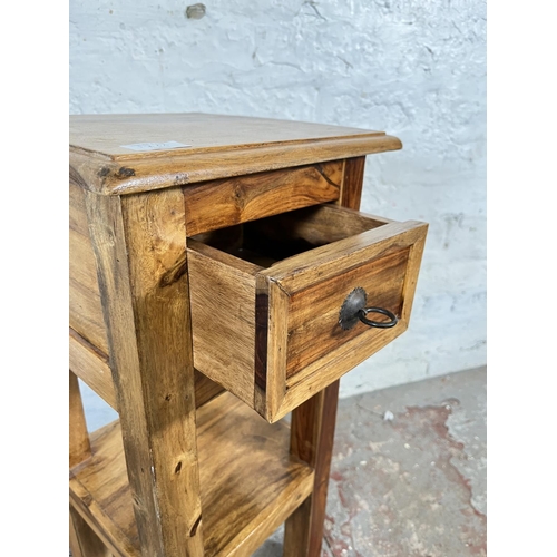 126A - An Indian Sheesham wood single drawer two tier lamp table - approx. 65.5cm high x 30.5cm wide x 30.5... 