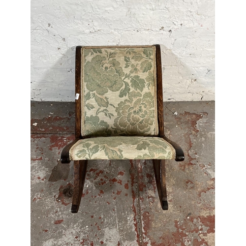 136 - An early 20th century oak and tapestry upholstered gout stool