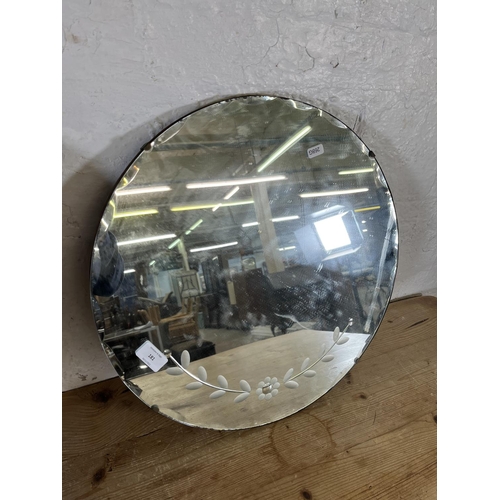 181 - Two mid 20th century frameless bevelled edge circular wall hanging mirrors