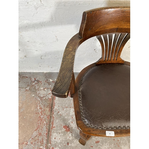 45 - A 1930s oak and brown leatherette desk chair