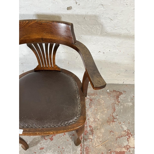 45 - A 1930s oak and brown leatherette desk chair