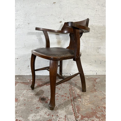 45 - A 1930s oak and brown leatherette desk chair