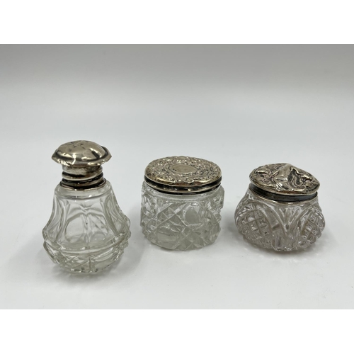 1257 - Seven ceramic and glass bottles and pots with hallmarked sterling silver tops - approx. gross silver... 