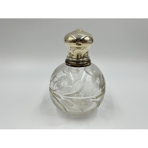 1258 - A cut glass hallmarked silver topped scent bottle - approx. 12.5cm high