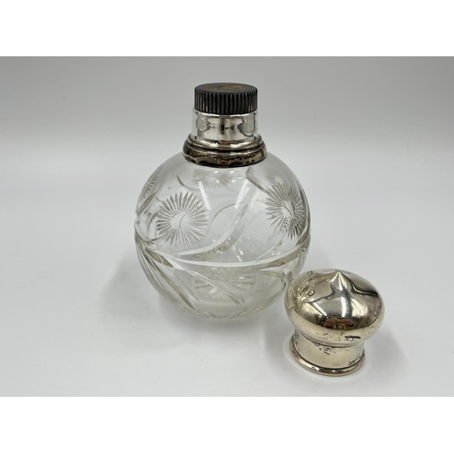 1258 - A cut glass hallmarked silver topped scent bottle - approx. 12.5cm high