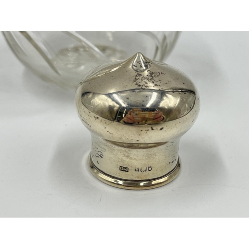 1258 - A cut glass hallmarked silver topped scent bottle - approx. 12.5cm high