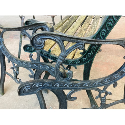 202B - Three items of garden furniture, one pair of cast iron bench ends, one wooden slatted and cast iron ... 