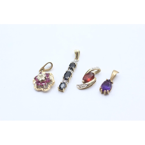 1005 - Four 9ct gold gemstone set pendants, one ruby and diamond, one sapphire and diamond, one garnet and ... 