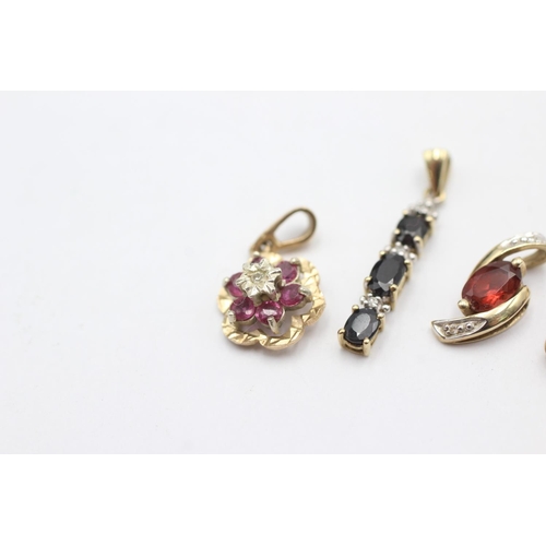 1005 - Four 9ct gold gemstone set pendants, one ruby and diamond, one sapphire and diamond, one garnet and ... 