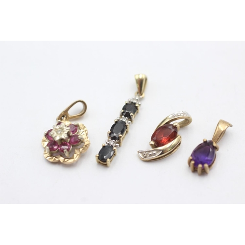 1005 - Four 9ct gold gemstone set pendants, one ruby and diamond, one sapphire and diamond, one garnet and ... 