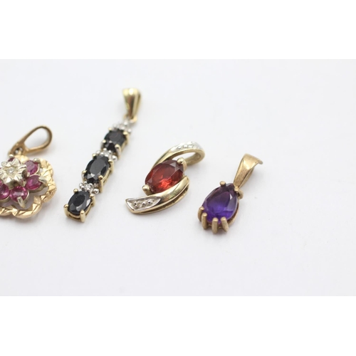 1005 - Four 9ct gold gemstone set pendants, one ruby and diamond, one sapphire and diamond, one garnet and ... 