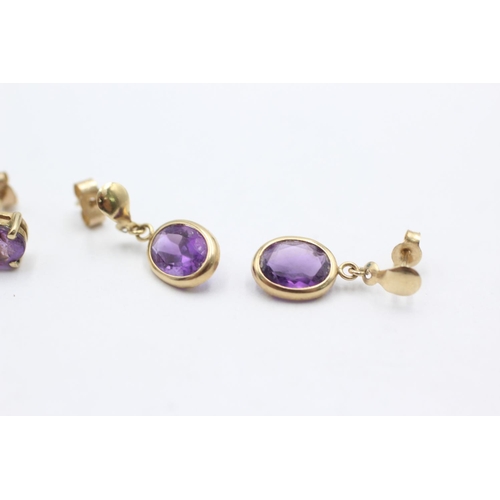 1006 - Two pairs of 9ct gold amethyst earrings - approx. gross weight 1.9 grams