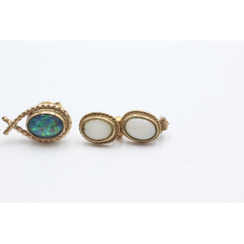 1007 - Two pairs of 9ct gold opal stud earrings - approx. gross weight 3.6 grams