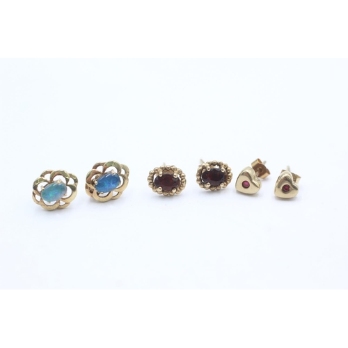 1009 - Three pairs of 9ct gold gemstone earrings, one opal, one ruby and one garnet - approx. gross weight ... 