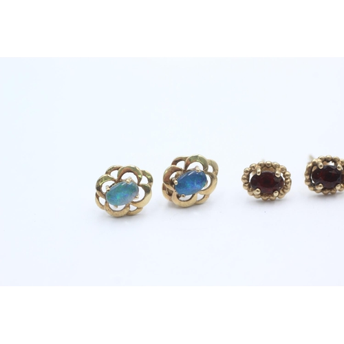 1009 - Three pairs of 9ct gold gemstone earrings, one opal, one ruby and one garnet - approx. gross weight ... 