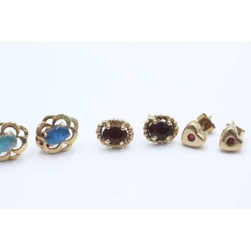 1009 - Three pairs of 9ct gold gemstone earrings, one opal, one ruby and one garnet - approx. gross weight ... 