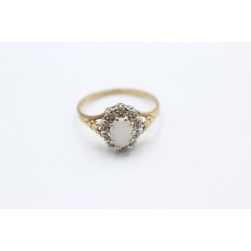 1018 - A 9ct gold opal and diamond halo dress ring, size O - approx. gross weight 2 grams