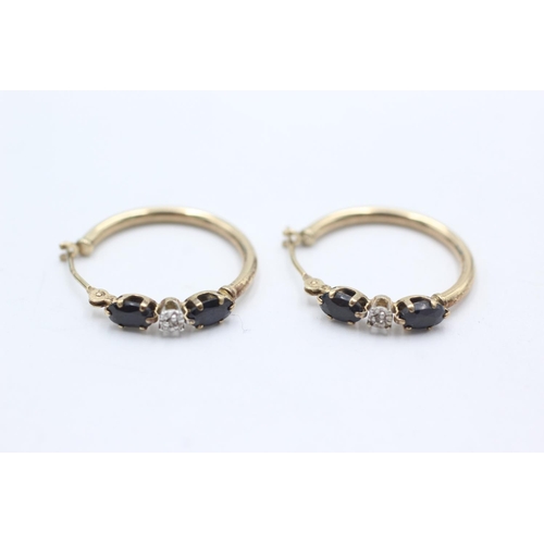 1021 - A pair of 9ct gold sapphire hoop earrings - approx. gross weight 1.2 grams