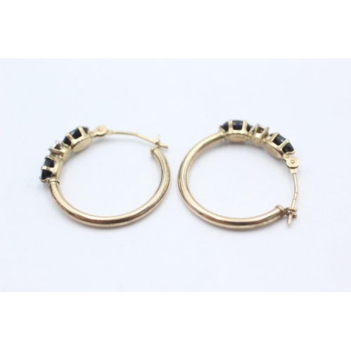 1021 - A pair of 9ct gold sapphire hoop earrings - approx. gross weight 1.2 grams