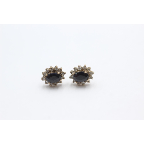 1025 - A pair of 9ct gold sapphire and diamond cluster stud earrings - approx. gross weight 1.5 grams