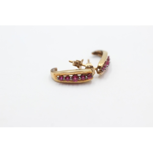 1026 - A pair of 9ct gold ruby half-hoop earrings - approx. gross weight 1.9 grams