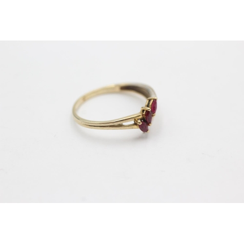 1028 - A 9ct gold diamond and ruby stylised wishbone ring, size R½ - approx. gross weight 1.7 grams