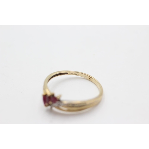 1028 - A 9ct gold diamond and ruby stylised wishbone ring, size R½ - approx. gross weight 1.7 grams