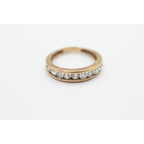 1050 - A 9ct gold clear gemstone half-eternity ring, size L - approx. gross weight 2.6 grams