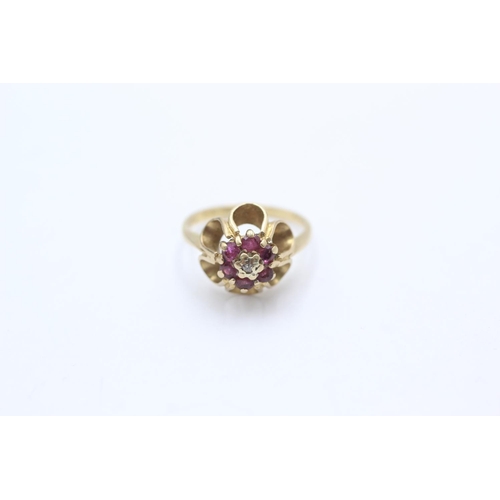 1054 - A 9ct gold diamond and ruby buttercup setting ring, size K - approx. gross weight 2.5 grams