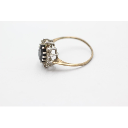 1056 - A 9ct gold sapphire and clear gemstone halo dress ring, size N - approx. gross weight 1.9 grams