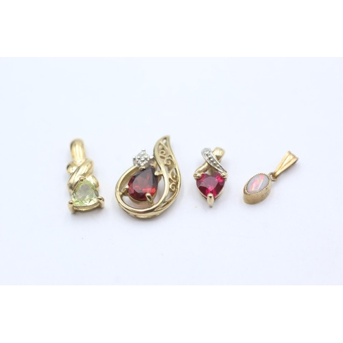 1057 - Four 9ct gold pendants, one opal, one garnet and diamond, one synthetic ruby and diamond and one syn... 