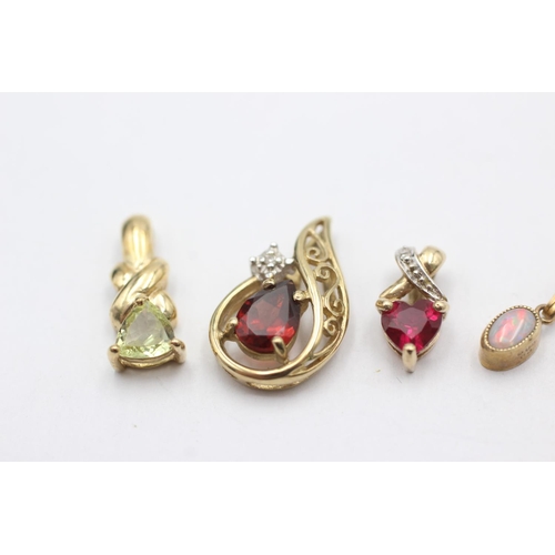 1057 - Four 9ct gold pendants, one opal, one garnet and diamond, one synthetic ruby and diamond and one syn... 