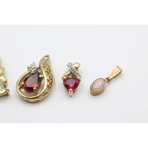 1057 - Four 9ct gold pendants, one opal, one garnet and diamond, one synthetic ruby and diamond and one syn... 