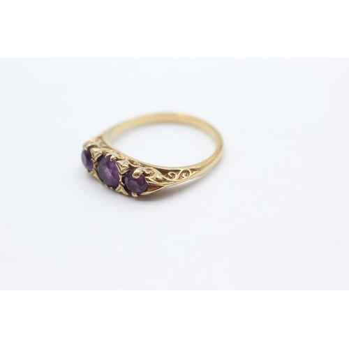 1062 - A 9ct gold amethyst three stone gypsy setting ring, size P - approx. gross weight 2.9 grams