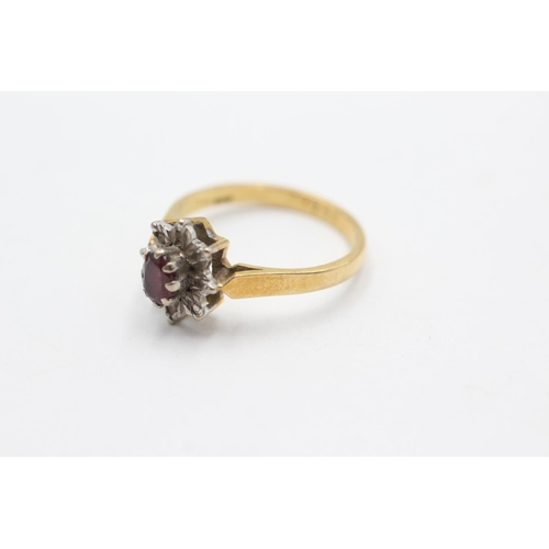 1066 - A 18ct gold ruby and diamond star cluster ring, size N - approx. gross weight 3.4 grams