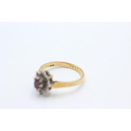 1066 - A 18ct gold ruby and diamond star cluster ring, size N - approx. gross weight 3.4 grams