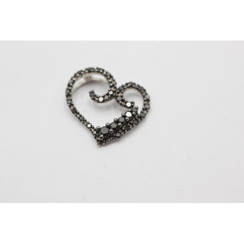 1071 - A 9ct white gold black diamond set heart pendant - approx. gross weight 1.2 grams