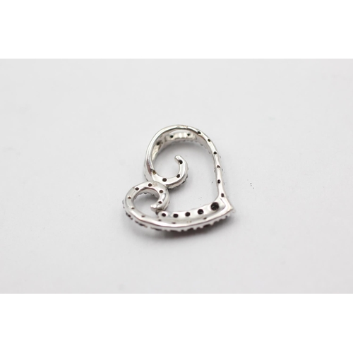 1071 - A 9ct white gold black diamond set heart pendant - approx. gross weight 1.2 grams