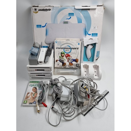 729 - A large collection of Nintendo Wii items to include three consoles, third-party fitness board, vario... 