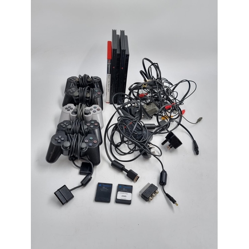 730 - Two PlayStation 2 slim consoles with various cables and accessories