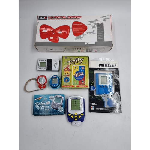 739 - A collection of toys and electronic games to include boxed remote-control helicopter, brick game, Su... 