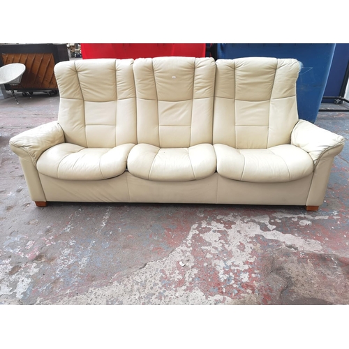 129 - An Ekornes Stressless cream leather reclining three seater sofa