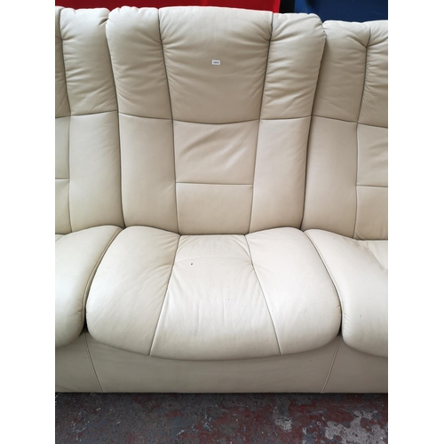 129 - An Ekornes Stressless cream leather reclining three seater sofa