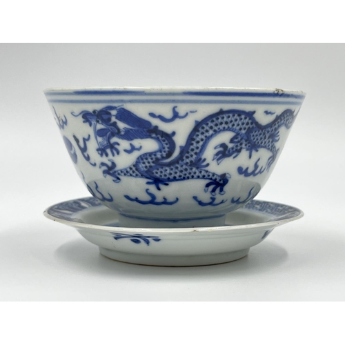 214 - A Chinese blue and white porcelain tea bowl and saucer, both showing four character marks to base - ... 