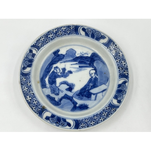 214 - A Chinese blue and white porcelain tea bowl and saucer, both showing four character marks to base - ... 