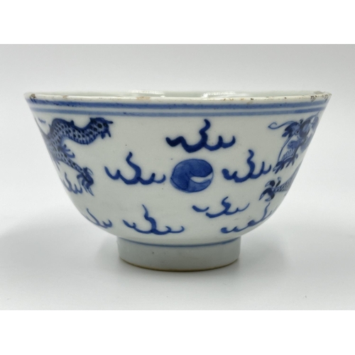 214 - A Chinese blue and white porcelain tea bowl and saucer, both showing four character marks to base - ... 