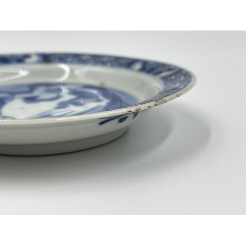 214 - A Chinese blue and white porcelain tea bowl and saucer, both showing four character marks to base - ... 