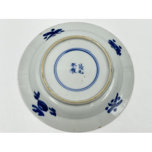 214 - A Chinese blue and white porcelain tea bowl and saucer, both showing four character marks to base - ... 