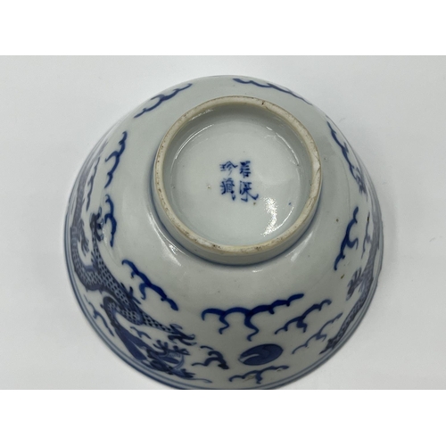 214 - A Chinese blue and white porcelain tea bowl and saucer, both showing four character marks to base - ... 