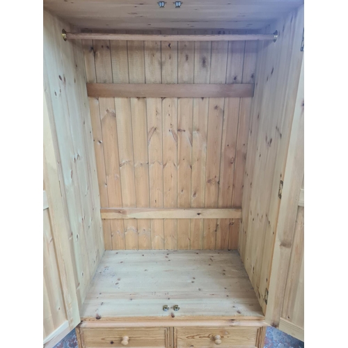 10 - A modern solid pine double wardrobe with two lower short drawers and one long drawer - approx. 193cm... 